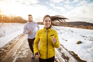 Couple running outside in winter 